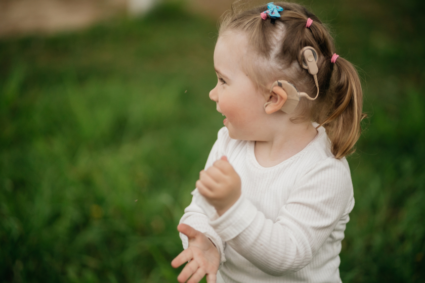 Cheerful toddler girl with cochlear implants