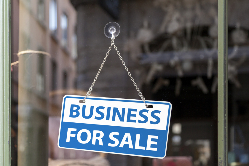 Business for sale sign on shop window.