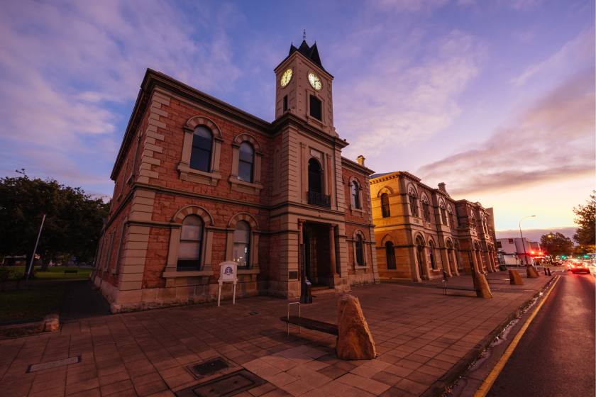 Historic Townhall Building. The building is Victorian esque and has the backdrop of a beautiful sunset. 