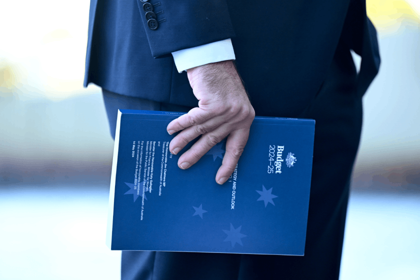 Photo of Jim Chalmers' hand holding the federal budget document