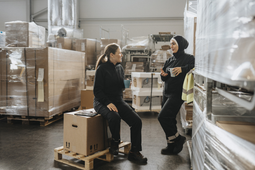 Female warehouse workers having a conversation during their break