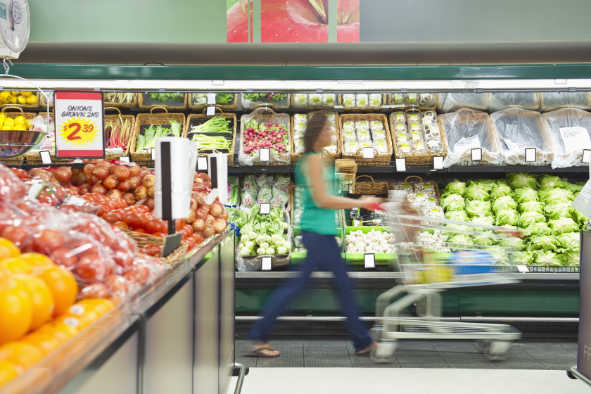 Woman at grocery aisle shopping for groceries 
