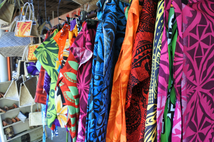 tropical shirts on a clothing rack at a sunday market